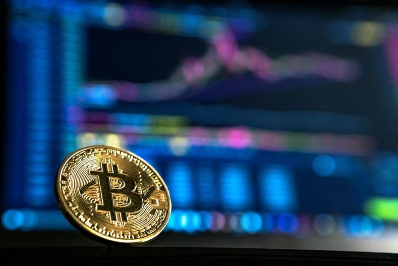 bitcoin in front of computer
