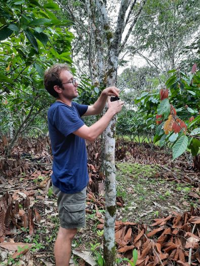 Charlie Tebbutt holds up a recorder in the Colombian Amazon.