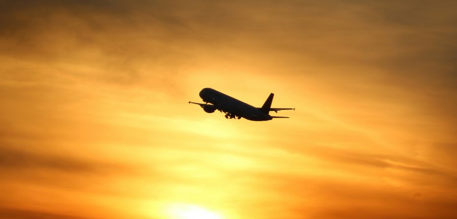 plane flying at sunset