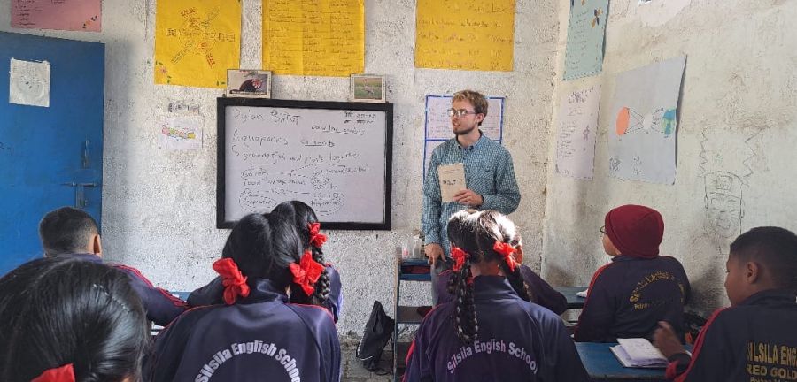 Fulbrighter Dylan Rodgers teaches English to a class of students in Nepal.