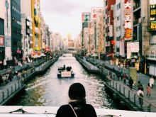 A photo of a person overlooking a bridge in Osaka, Japan