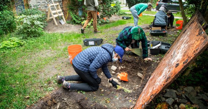 People dig at the base of a church believed to be part of the Underground Railroad
