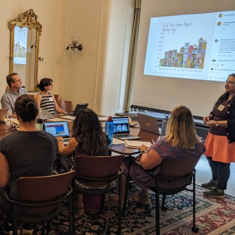 Teachers attend an ISSI workshop, looking up at a presentation. 