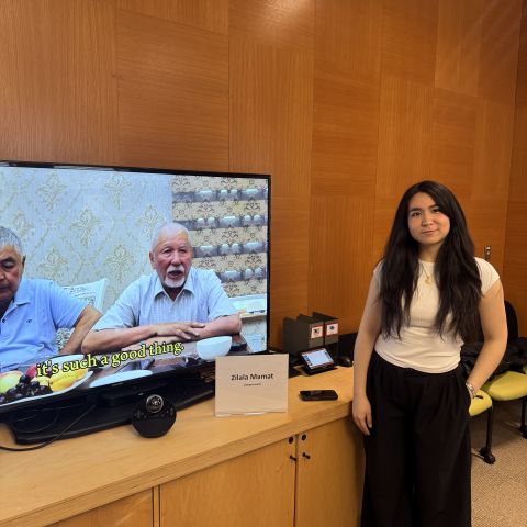 Global scholar shows their video project on a screen.