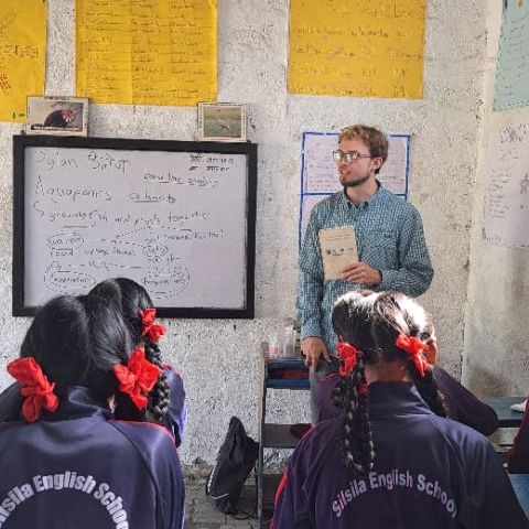 Fulbrighter Dylan Rodgers teaches English to a class of students in Nepal.
