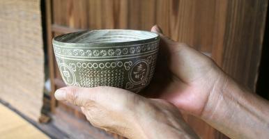 Offering tea in a Japanese tea bowl